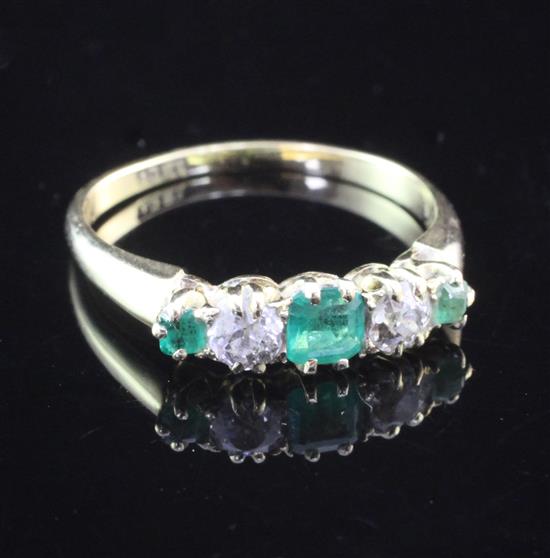 An 18ct gold, five stone emerald and diamond set half hoop ring, size Q.